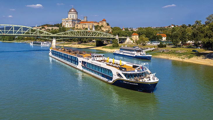 Spirit of the Danube sailing past the Esztergom Basilica in Hungary on a sunny day